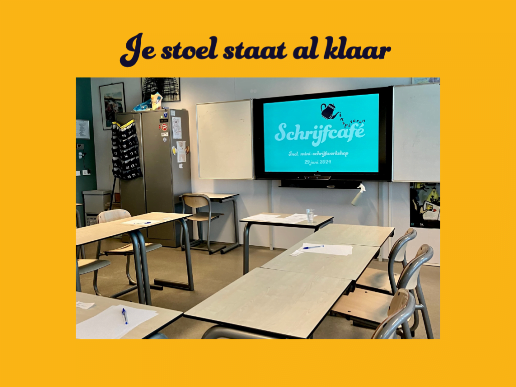 Foto van een klaslokaal. Op het digibord staat een presentatie aan, met de tekst Schrijfcafé. De tafels zijn in u-vorm opgesteld. Op de tafeltjes liggen notitieblaadjes en een pen.